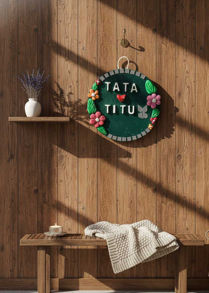 Decorative wall hanging with 'TATA TITU' text on a wooden wall.