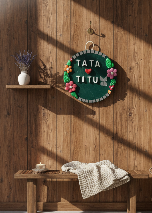 Decorative wall hanging with 'TATA TITU' text on a wooden wall.